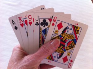 a hand holding playing cards